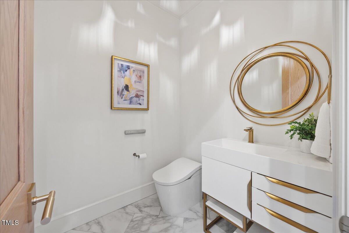 2120 Kipawa Street Raleigh, NC 27607 - Photo 24 of 77 a bathroom with a toilet a sink and a mirror