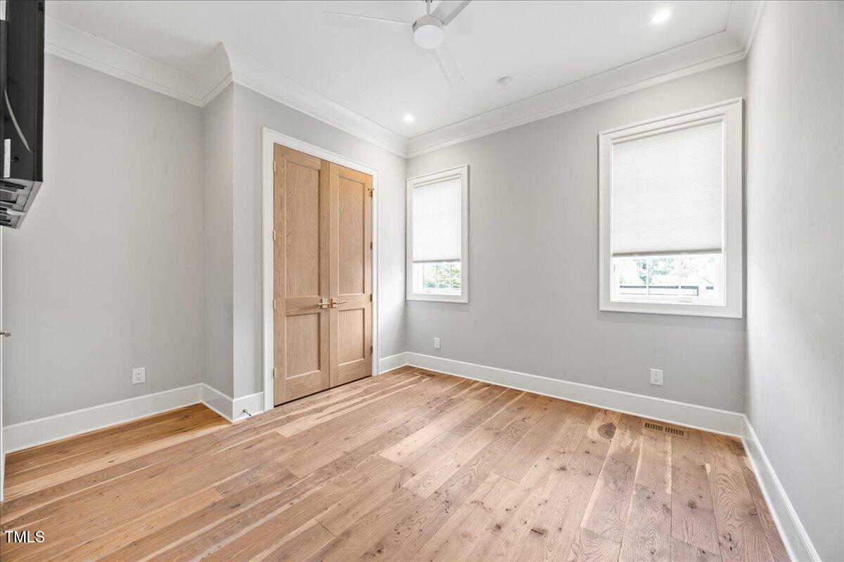 2120 Kipawa Street Raleigh, NC 27607 - Photo 25 of 77 an empty room with wooden floor and windows
