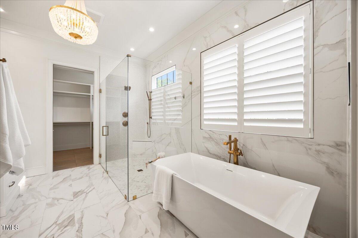 2120 Kipawa Street Raleigh, NC 27607 - Photo 32 of 77 a bathroom with a bathtub and a shower