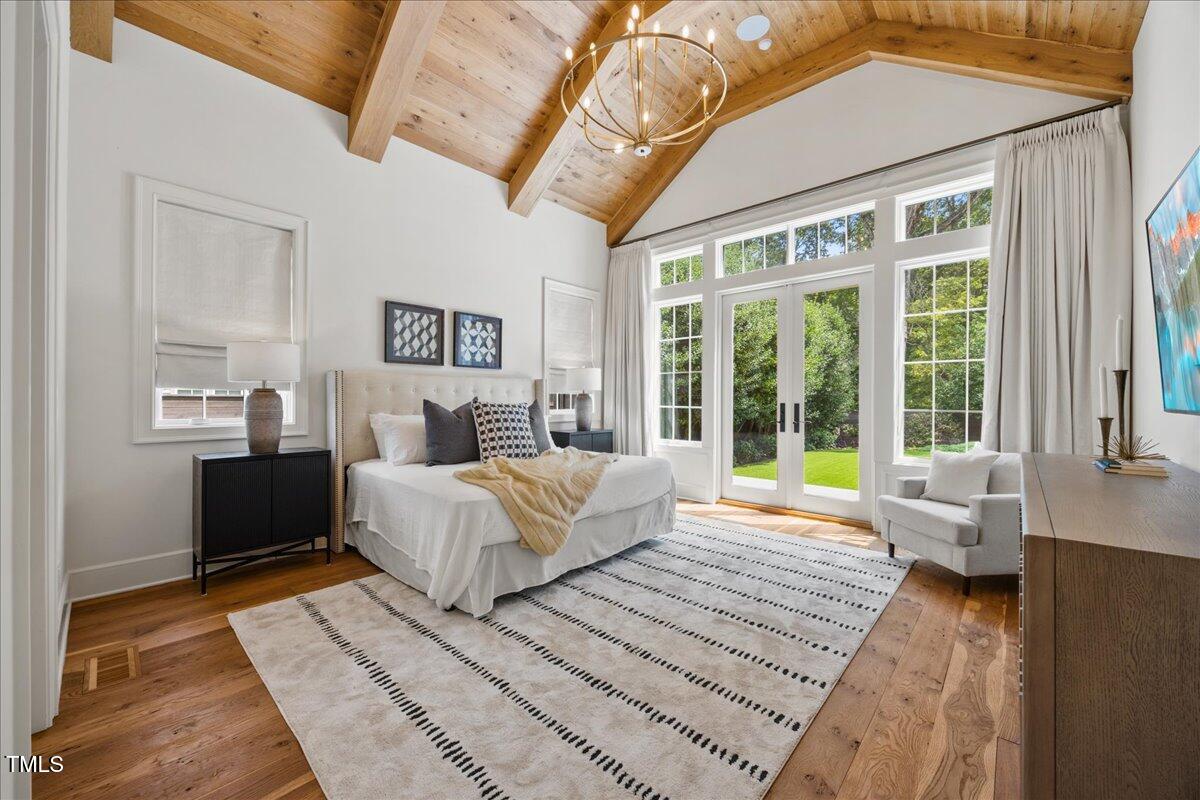 2120 Kipawa Street Raleigh, NC 27607 - Photo 34 of 77 a spacious bedroom with a large bed and a couch