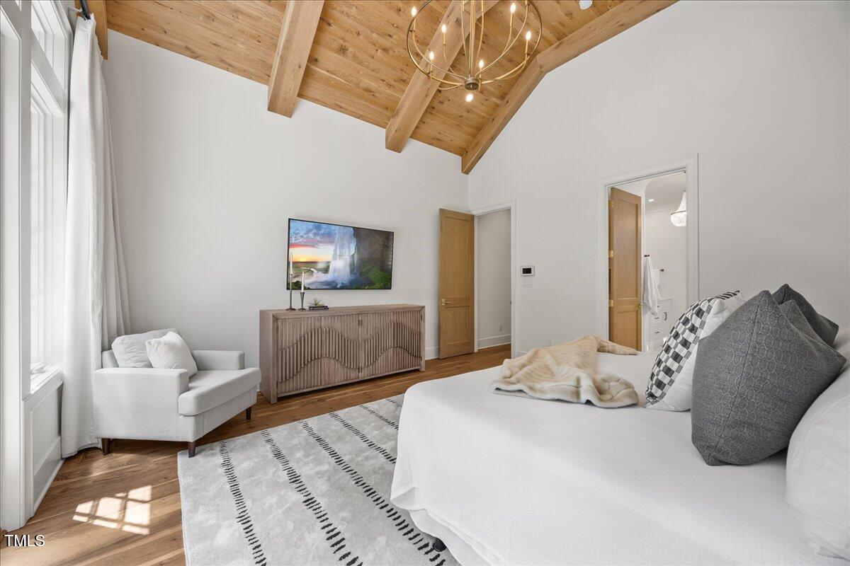 2120 Kipawa Street Raleigh, NC 27607 - Photo 35 of 77 a bedroom with a bed and wooden floor