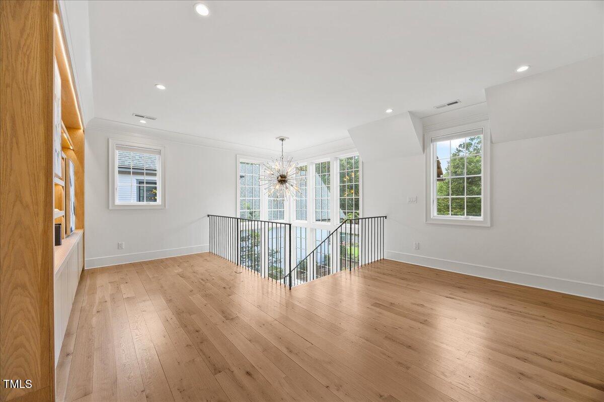 2120 Kipawa Street Raleigh, NC 27607 - Photo 39 of 77 an empty room with wooden floor and windows