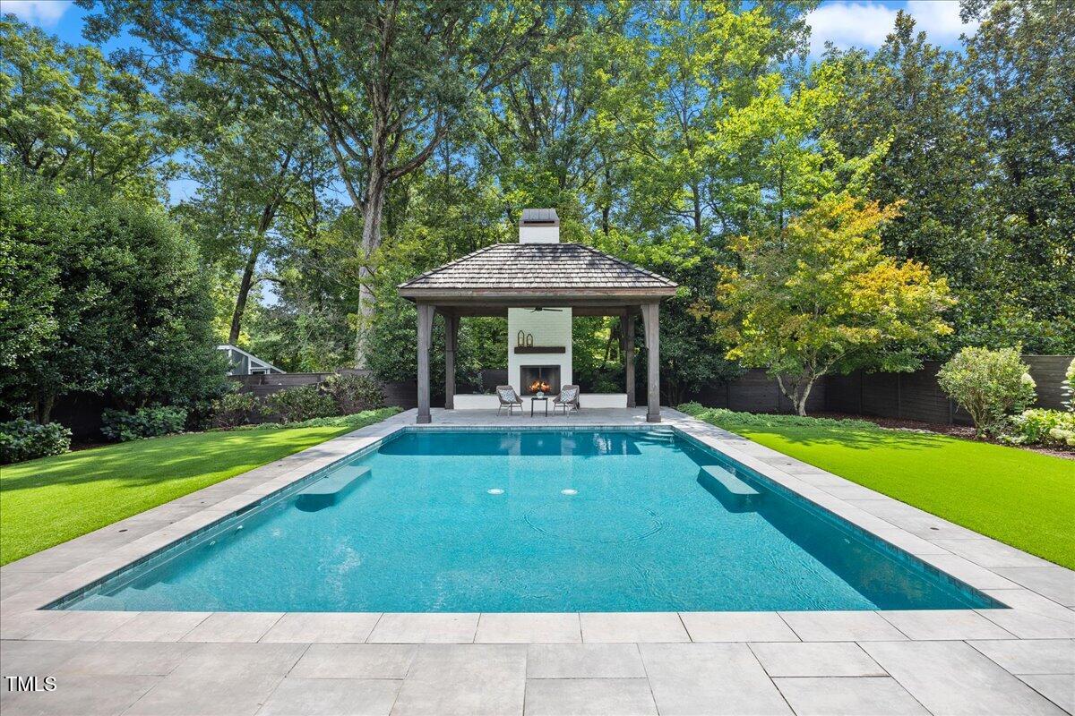 2120 Kipawa Street Raleigh, NC 27607 - Photo 4 of 77 a view of swimming pool with lawn chairs and large trees