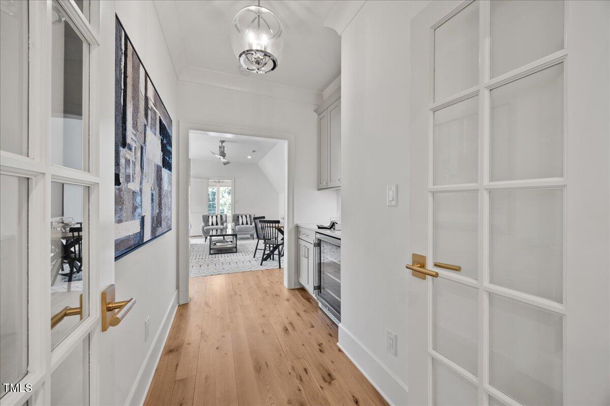 2120 Kipawa Street Raleigh, NC 27607 - Photo 41 of 77 a view of a hallway with wooden floor and staircase