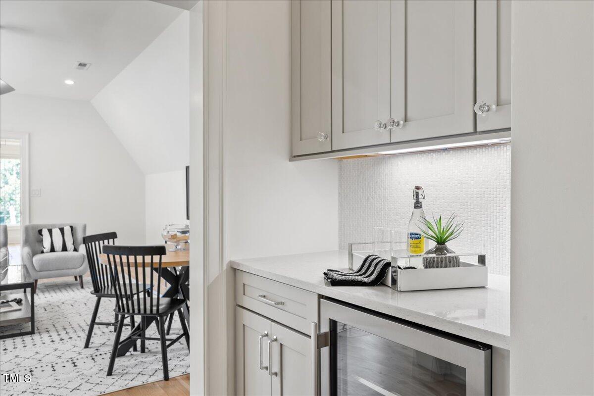 2120 Kipawa Street Raleigh, NC 27607 - Photo 42 of 77 a kitchen with stainless steel appliances granite countertop a sink a stove and white cabinets