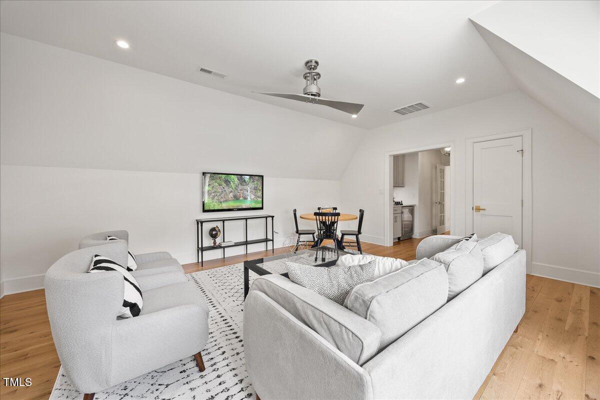2120 Kipawa Street Raleigh, NC 27607 - Photo 45 of 77 a living room with furniture and a large mirror