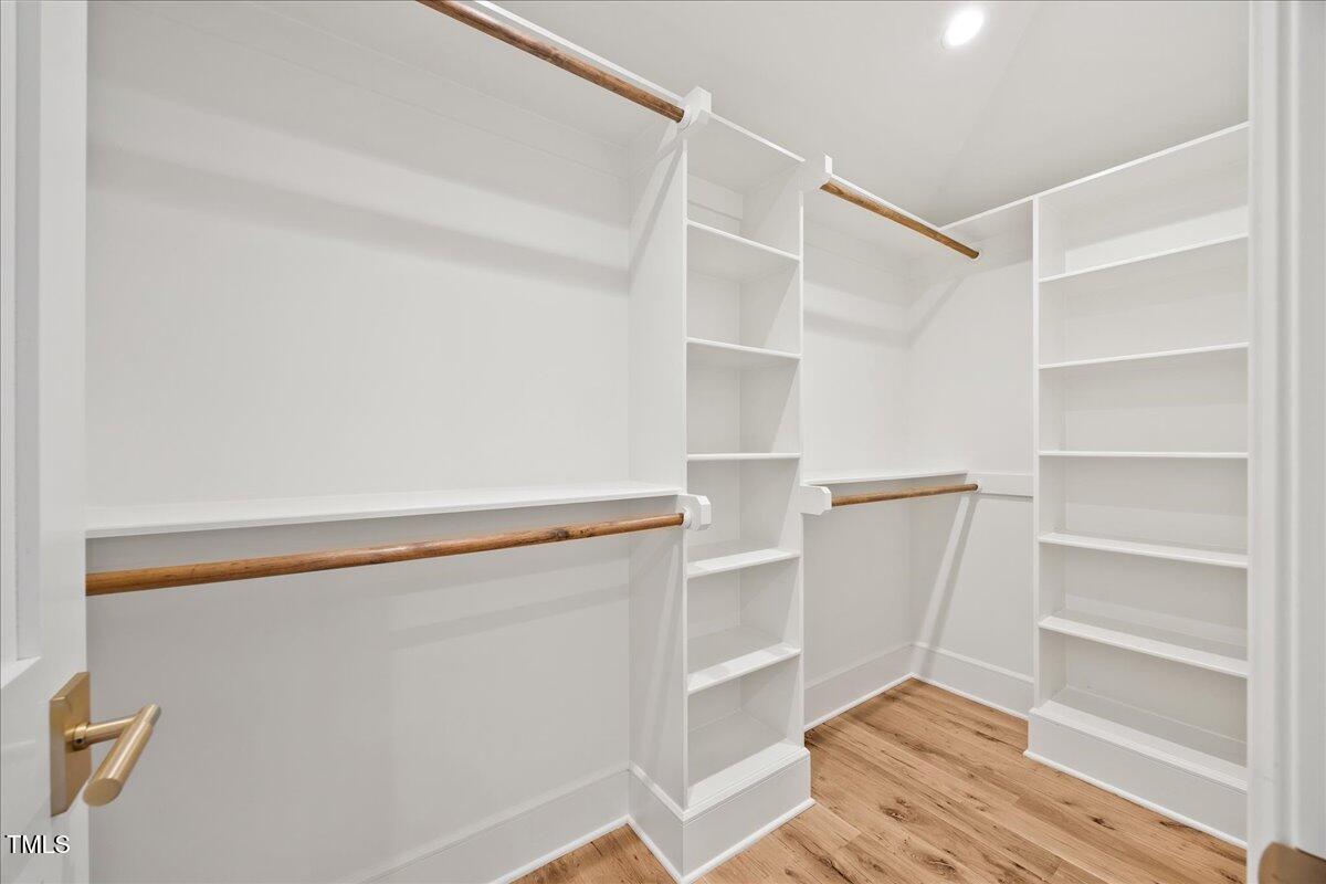 2120 Kipawa Street Raleigh, NC 27607 - Photo 51 of 77 a view of walk in closet with empty racks