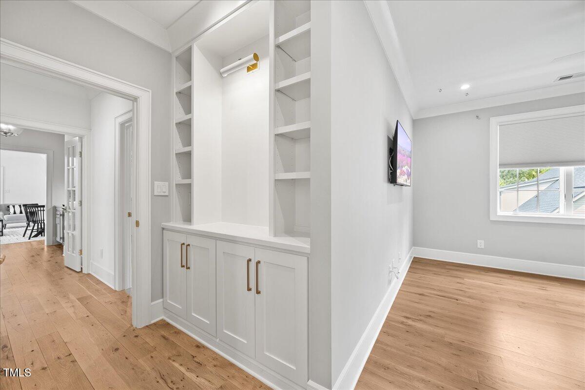 2120 Kipawa Street Raleigh, NC 27607 - Photo 52 of 77 a view of a hallway with wooden floor and staircase