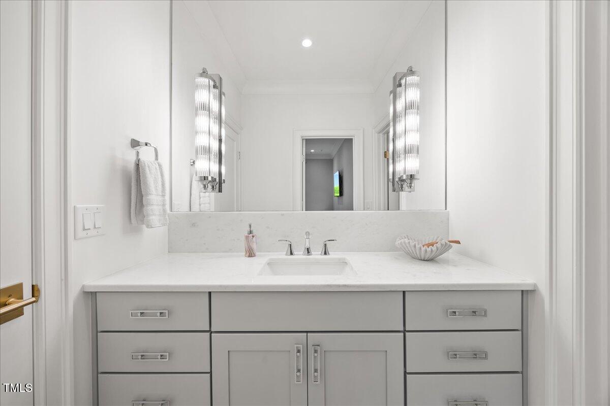 2120 Kipawa Street Raleigh, NC 27607 - Photo 56 of 77 a bathroom with a sink vanity and a mirror