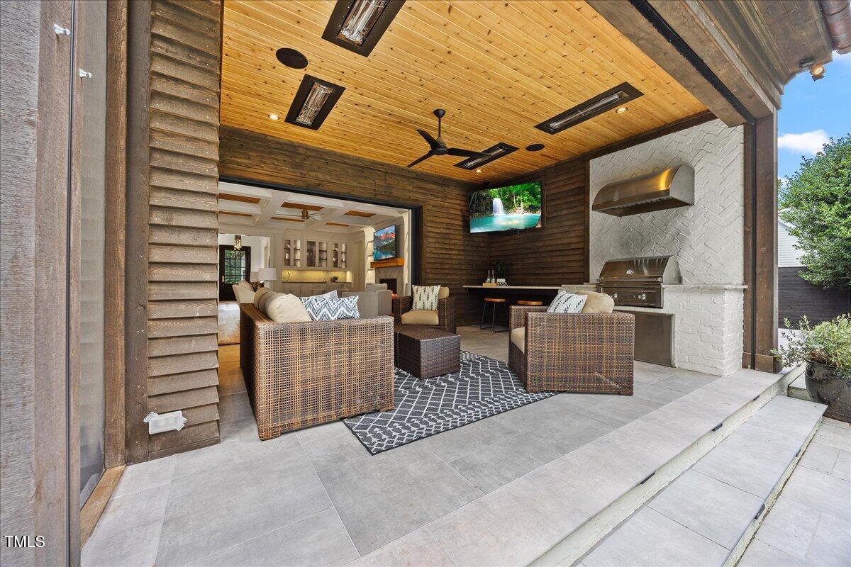 2120 Kipawa Street Raleigh, NC 27607 - Photo 65 of 77 a view of a patio with dining table and chairs