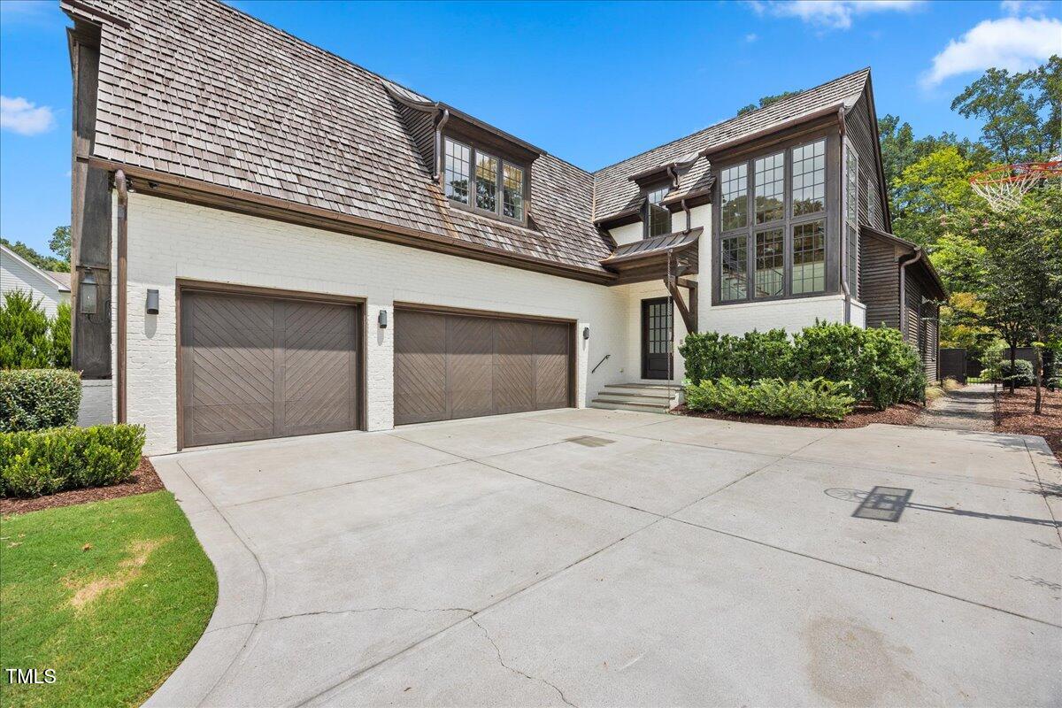 2120 Kipawa Street Raleigh, NC 27607 - Photo 77 of 77 a front view of a house with a yard and garage