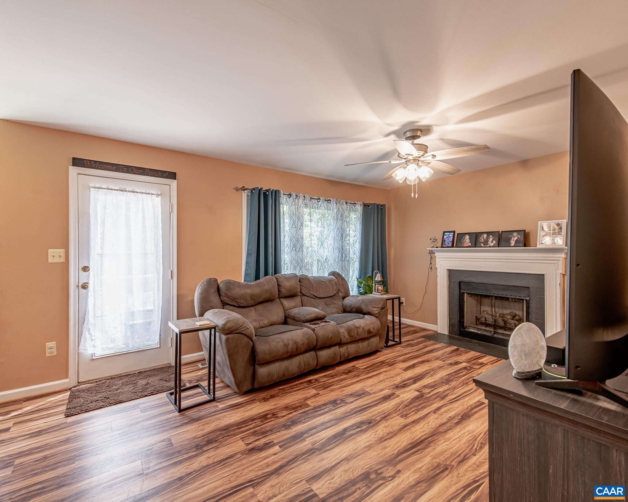 28276 Walnut Ridge Way Rhoadesville, VA 22542 - Photo 11 of 37 a living room with furniture and a fireplace