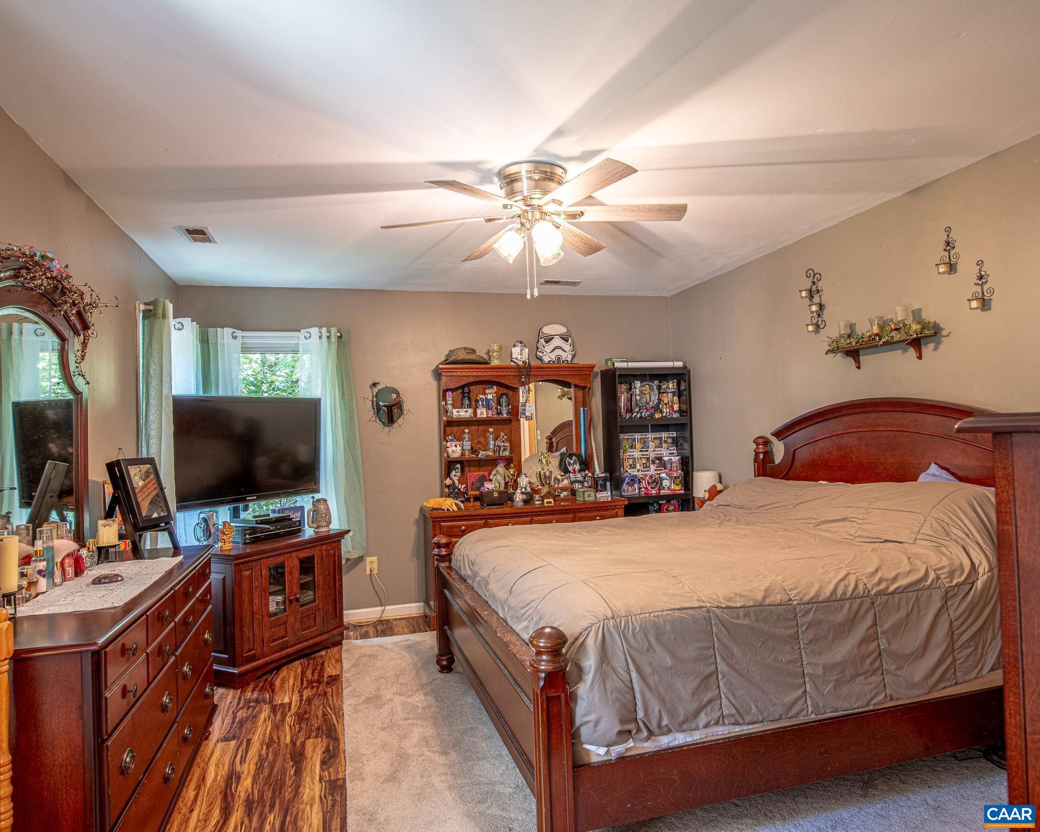 28276 Walnut Ridge Way Rhoadesville, VA 22542 - Photo 19 of 37 a bedroom with a bed and a flat tv screen on dresser