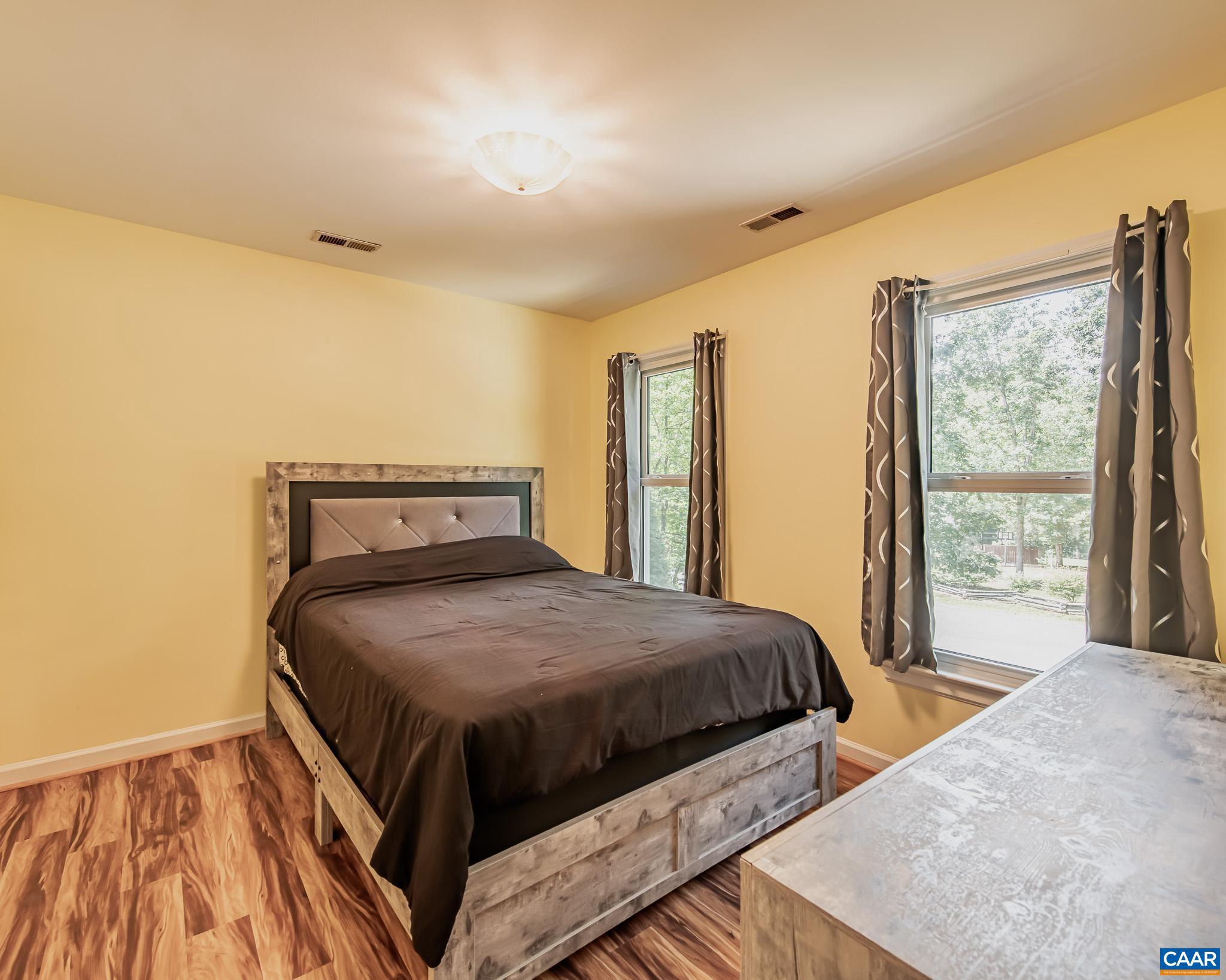 28276 Walnut Ridge Way Rhoadesville, VA 22542 - Photo 22 of 37 a bedroom with a bed and wooden floor