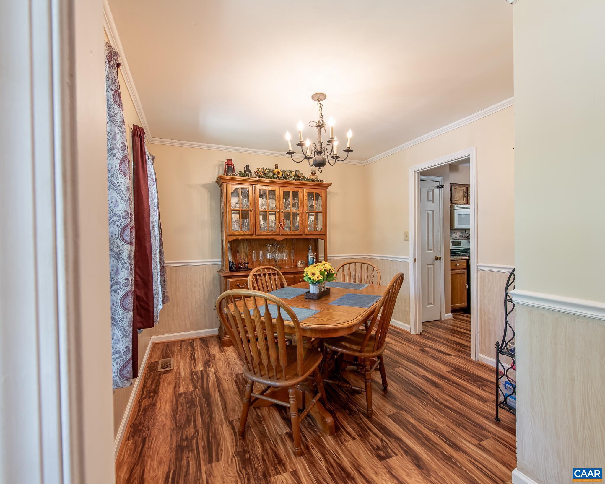 28276 Walnut Ridge Way Rhoadesville, VA 22542 - Photo 5 of 37 a view of a dining room with furniture and chandelier