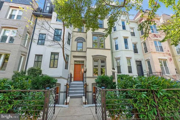 a view of a brick building next to a yard