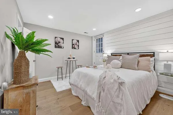 a bedroom with bed and a potted plant