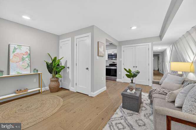 1450 Fairmont Street Northwest, Unit A Washington, DC 20009 - Photo 5 of 14 a living room with furniture and a potted plant