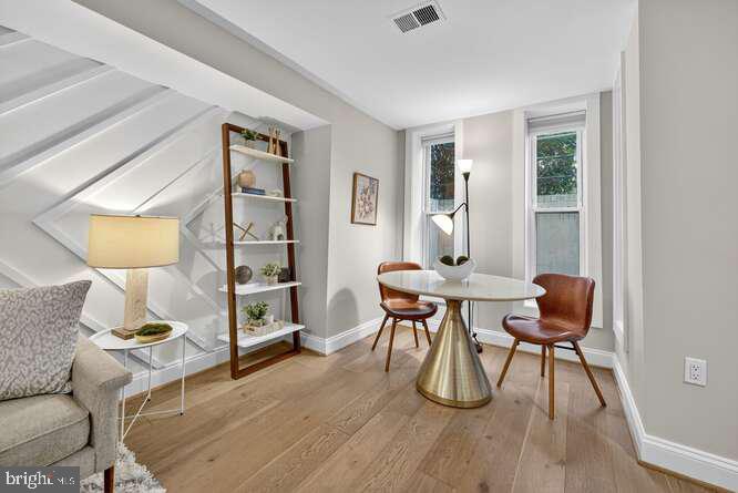 1450 Fairmont Street Northwest, Unit A Washington, DC 20009 - Photo 6 of 14 a workspace with furniture and wooden floor