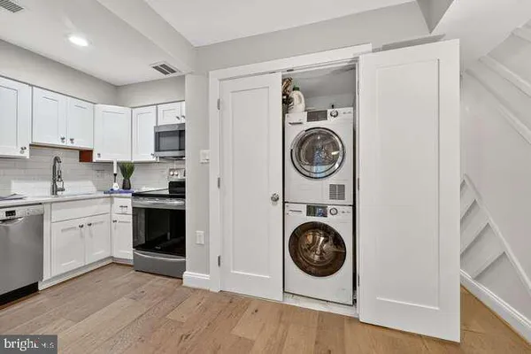 a view of a kitchen with washer and dryer