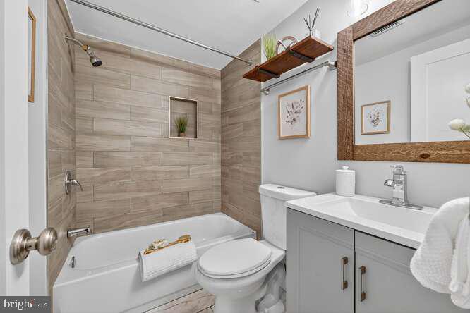 1450 Fairmont Street Northwest, Unit A Washington, DC 20009 - Photo 10 of 14 a bathroom with a sink a toilet and shower