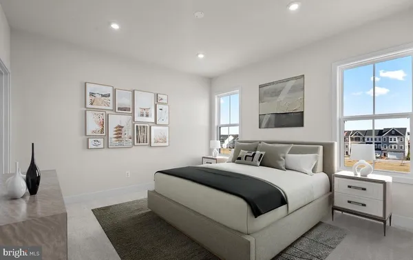 a bedroom with a large bed and white walls