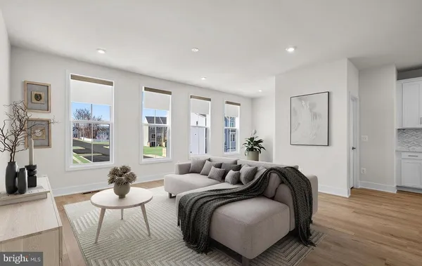 a spacious bedroom with a bed and wooden floor