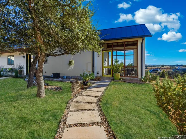 a bedroom with a large bed and a large window with outer view