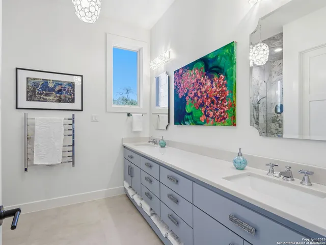 a bedroom with furniture and a large window