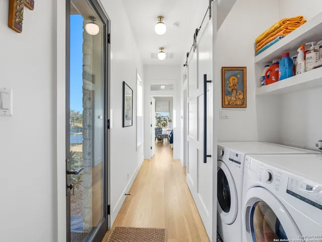 a view of a patio with a table chairs potted plants and a big yard