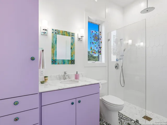 a view of a lake with a yard and large trees