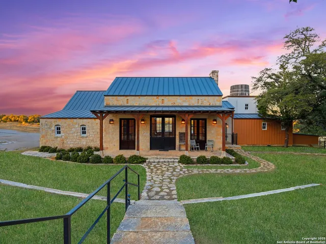 an aerial view of a house with yard