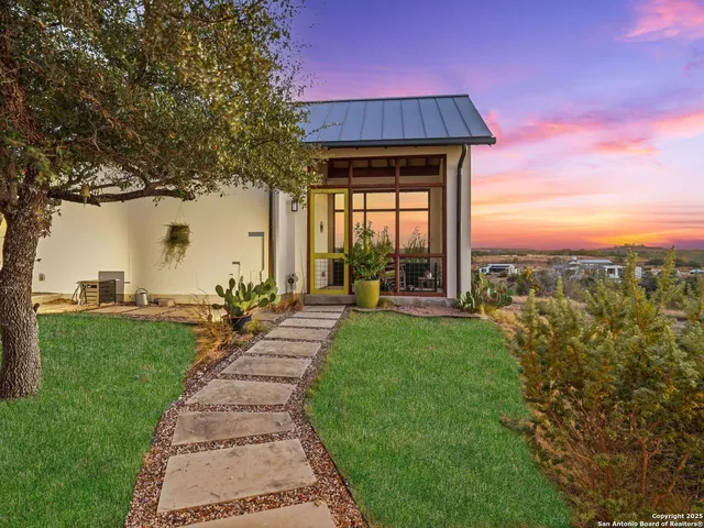a kitchen with stainless steel appliances kitchen island granite countertop a sink a stove and a wooden floors