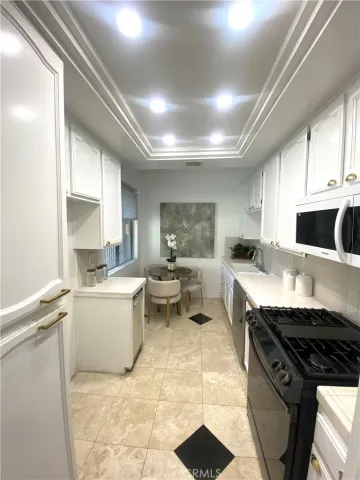 a stove top oven sitting inside of a kitchen
