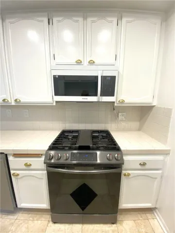 a spacious bathroom with a bathtub sink and mirror