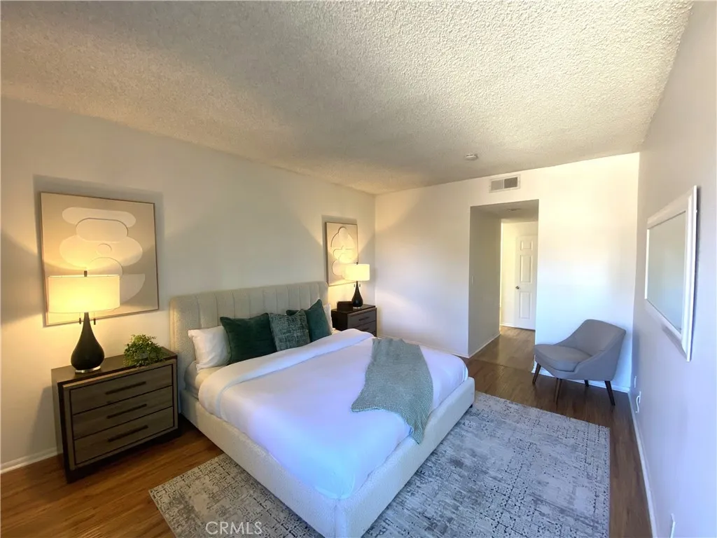 330 Cordova Street, Unit 261 Pasadena, CA 91101 - Photo 18 of 42 a bedroom with a bed and wooden floor