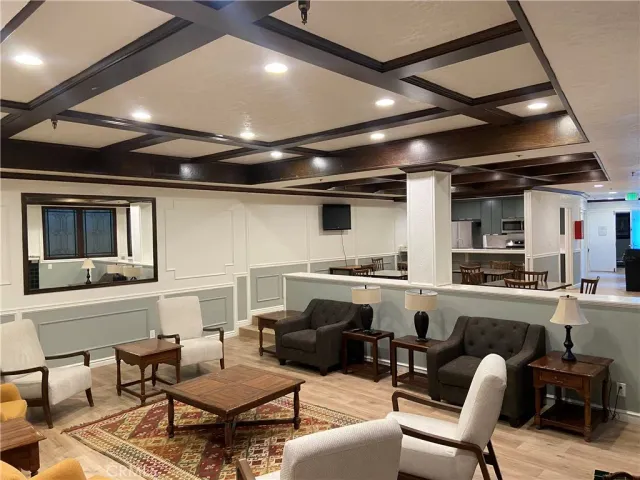 a living room with furniture and kitchen view