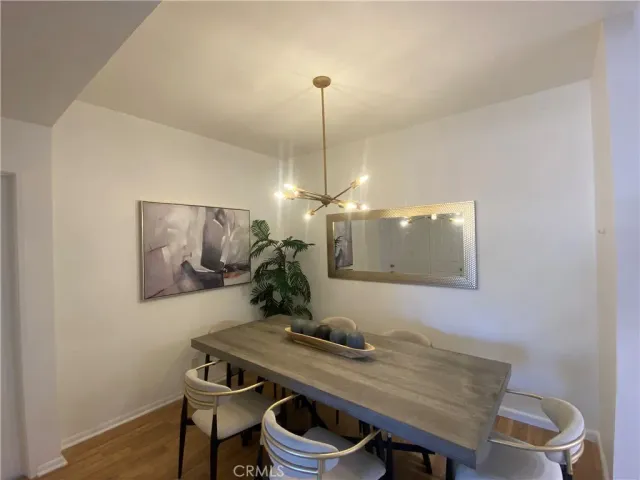 a dining room with table chairs and window