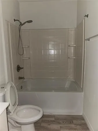 a bathroom with a toilet and shower