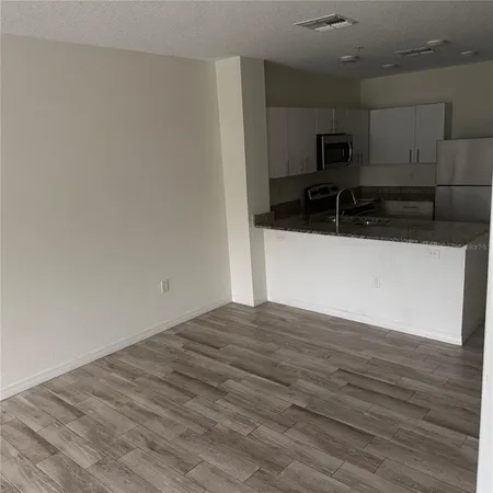 a view of a kitchen with a sink and a microwave
