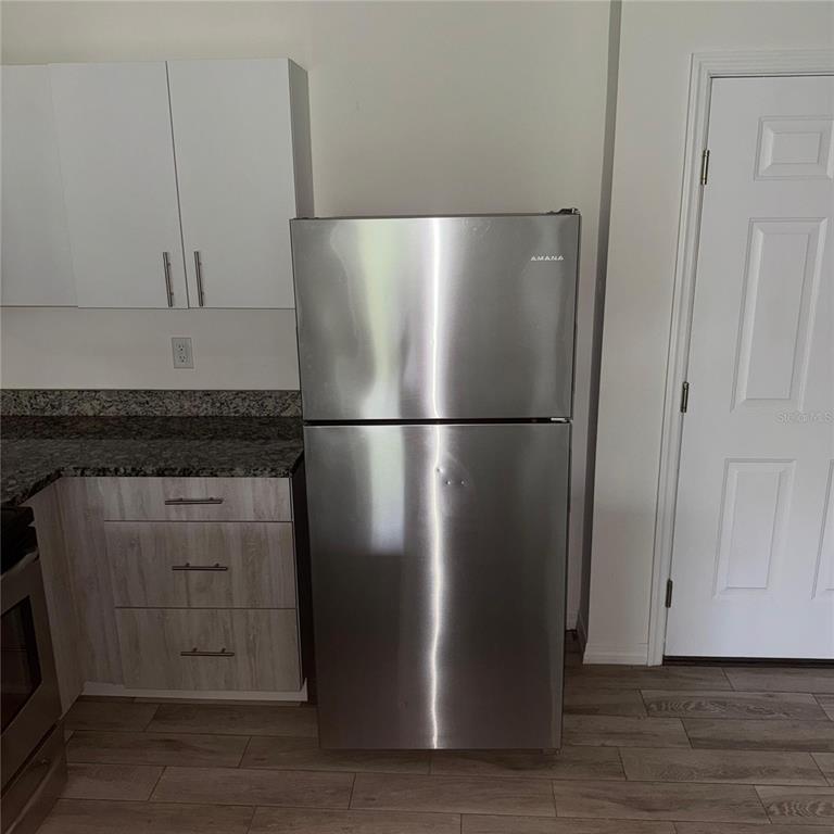 2121 McCoy Road, Unit 302 Orlando, FL 32809 - Photo 22 of 26 a close view of a refrigerator in kitchen