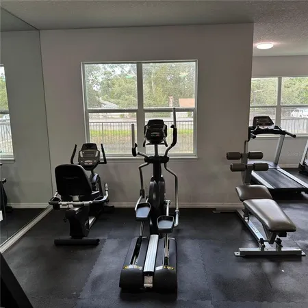 a room with gym equipment and a large window