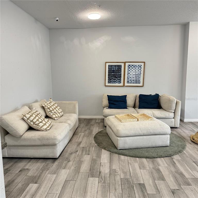 2121 McCoy Road, Unit 302 Orlando, FL 32809 - Photo 5 of 26 a bedroom with a bed and a couch