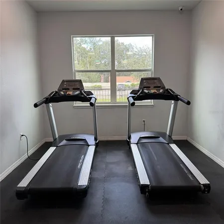 a room with gym equipment and a window
