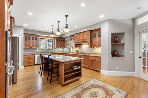 a kitchen with stainless steel appliances granite countertop a stove and a refrigerator
