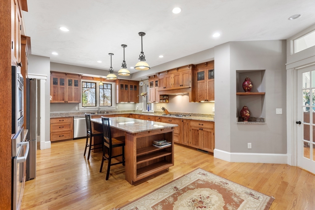 144 Brook Street Hudson, MA 01749 - Photo 14 of 44 a kitchen with stainless steel appliances granite countertop a stove and a refrigerator