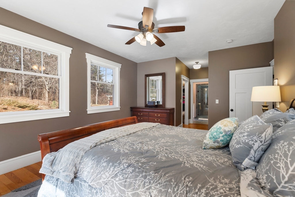 144 Brook Street Hudson, MA 01749 - Photo 20 of 44 a bedroom with a large bed chandelier and a window