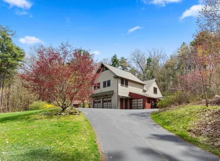 a view of house with a yard