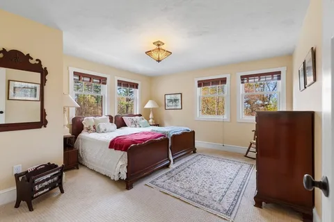 a spacious bedroom with a bed and a window