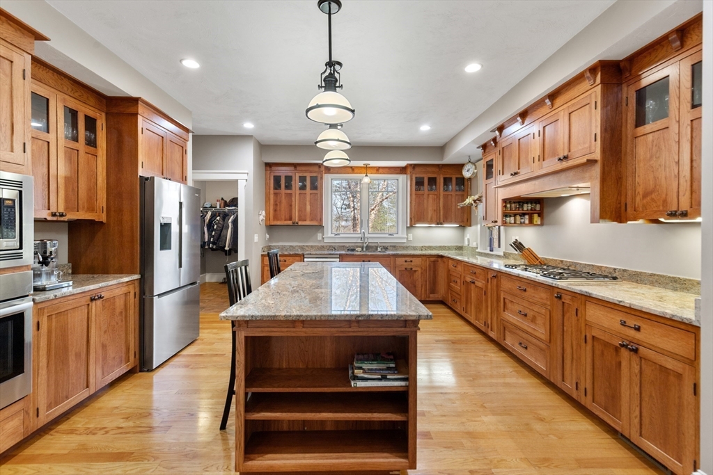 144 Brook Street Hudson, MA 01749 - Photo 3 of 44 a large kitchen with stainless steel appliances granite countertop plenty wooden cabinets counter space a sink and a center island
